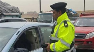 بطل مرور يزيل خطر الأسفلت الضار من الطريق بيديه لحماية المارة